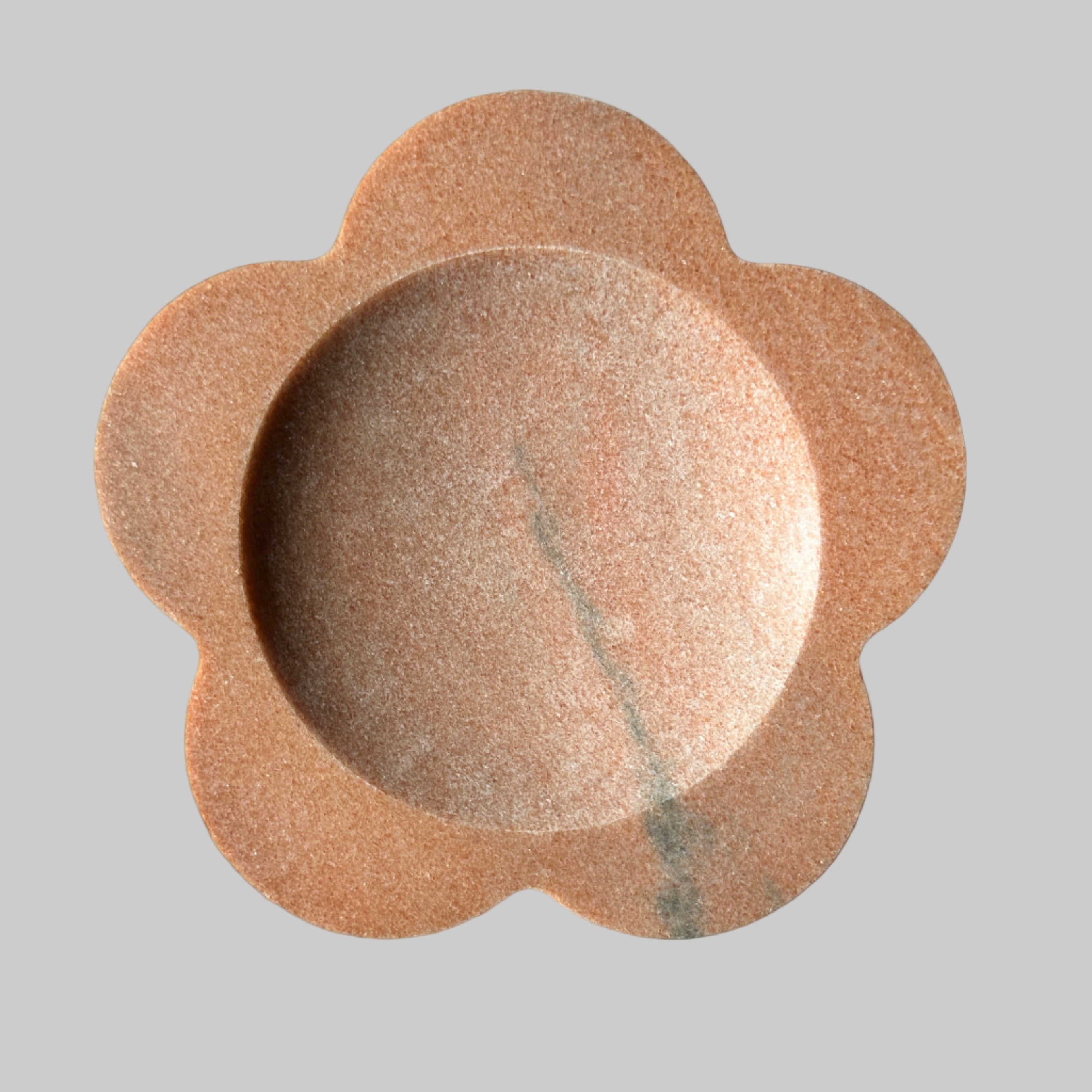 Decorative stone bowl with a natural brown color on a light background