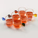 Set of six glass cups with colorful leaf-shaped handles on a white background